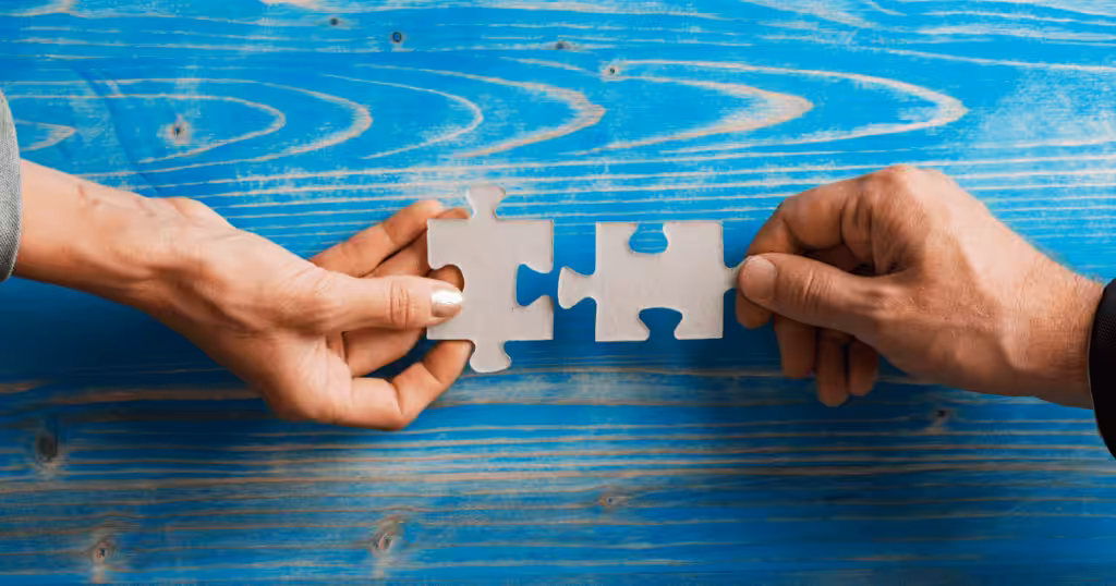 Two puzzle pieces coming together to represent the Director led matching process for specialized therapy in The Woodlands