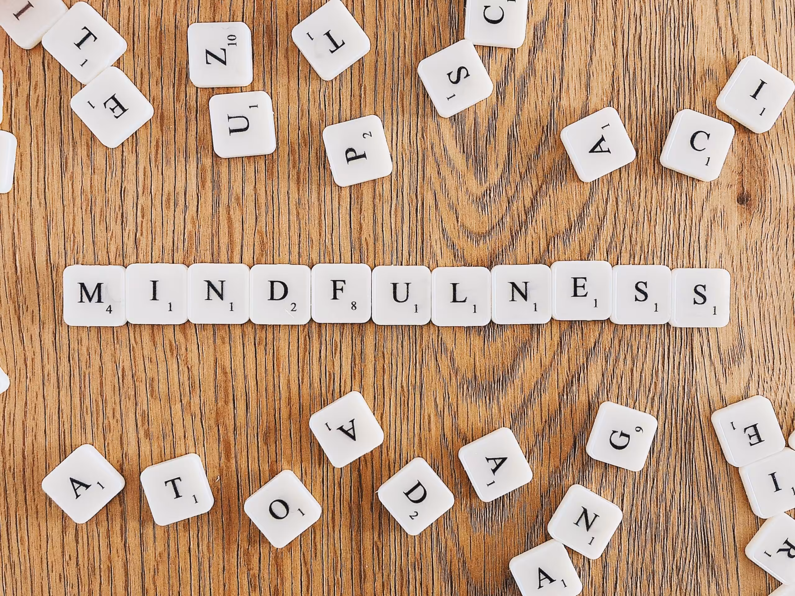 Scrabble tiles spelling out MINDFULNESS on a wooden surface highlighting the psychological and clinical Mindfulness Based Emotional Regulation in Houston Willowbrook