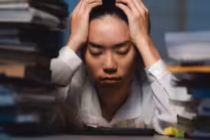 Latenight freelancer Dedicated Asian woman working overtime on laptop computer meeting deadlines Acceptance Path Counseling A high achieving professional in Louetta experiencing high functioning anxiety while managing a heavy workload near Houston Willowbrook