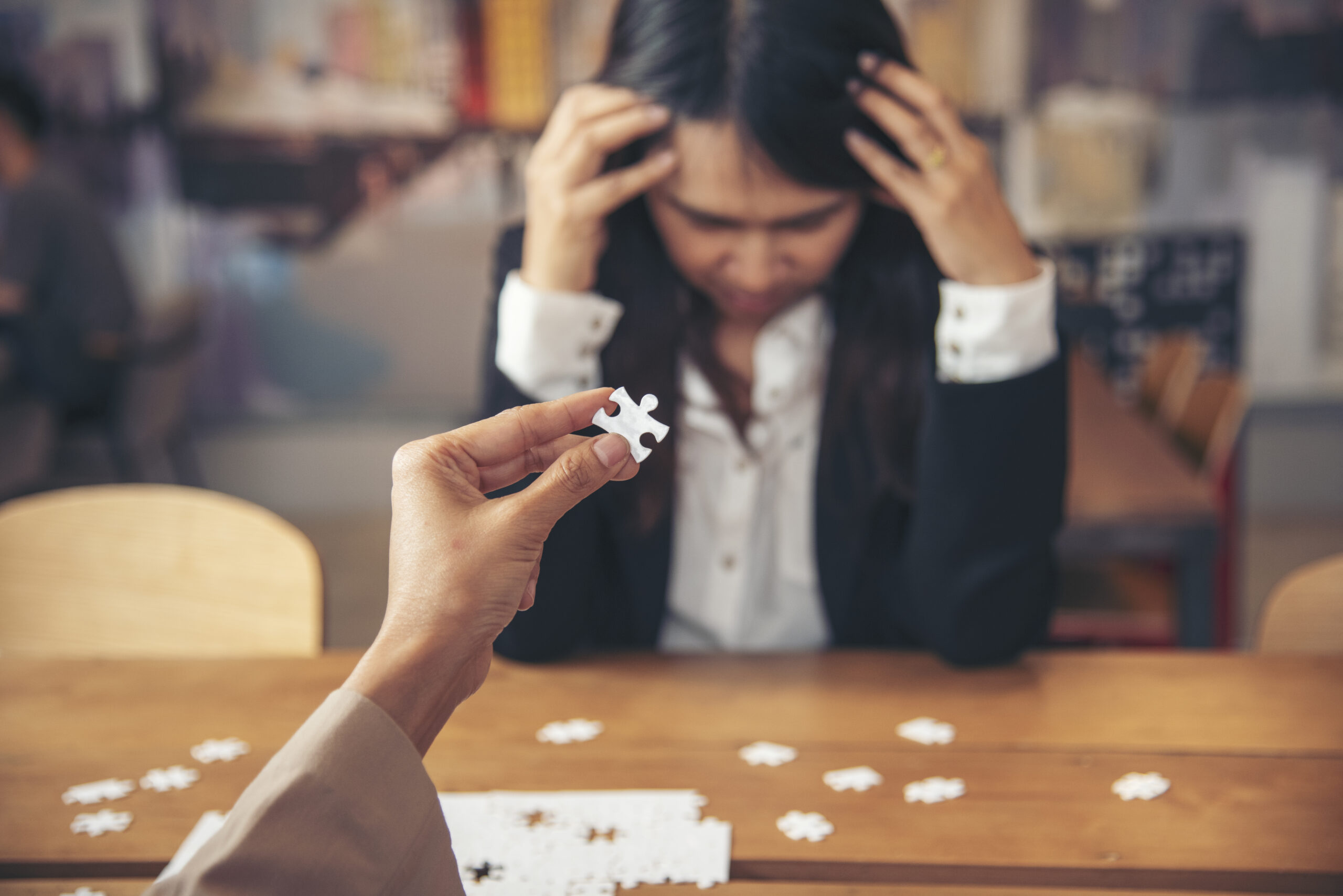asianbusinesswomanoverworkedatofficestressful20260327005346utc Acceptance Path Counseling Woman using a color coded planner in a The Woodlands coworking space Visualizes organizational tools and adhd strategies for adults trying to stay organized