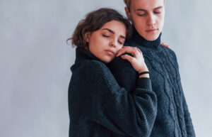 A young woman resting her head against her partners shoulder for emotional safety showcasing how to support someone with depression in a romantic relationship