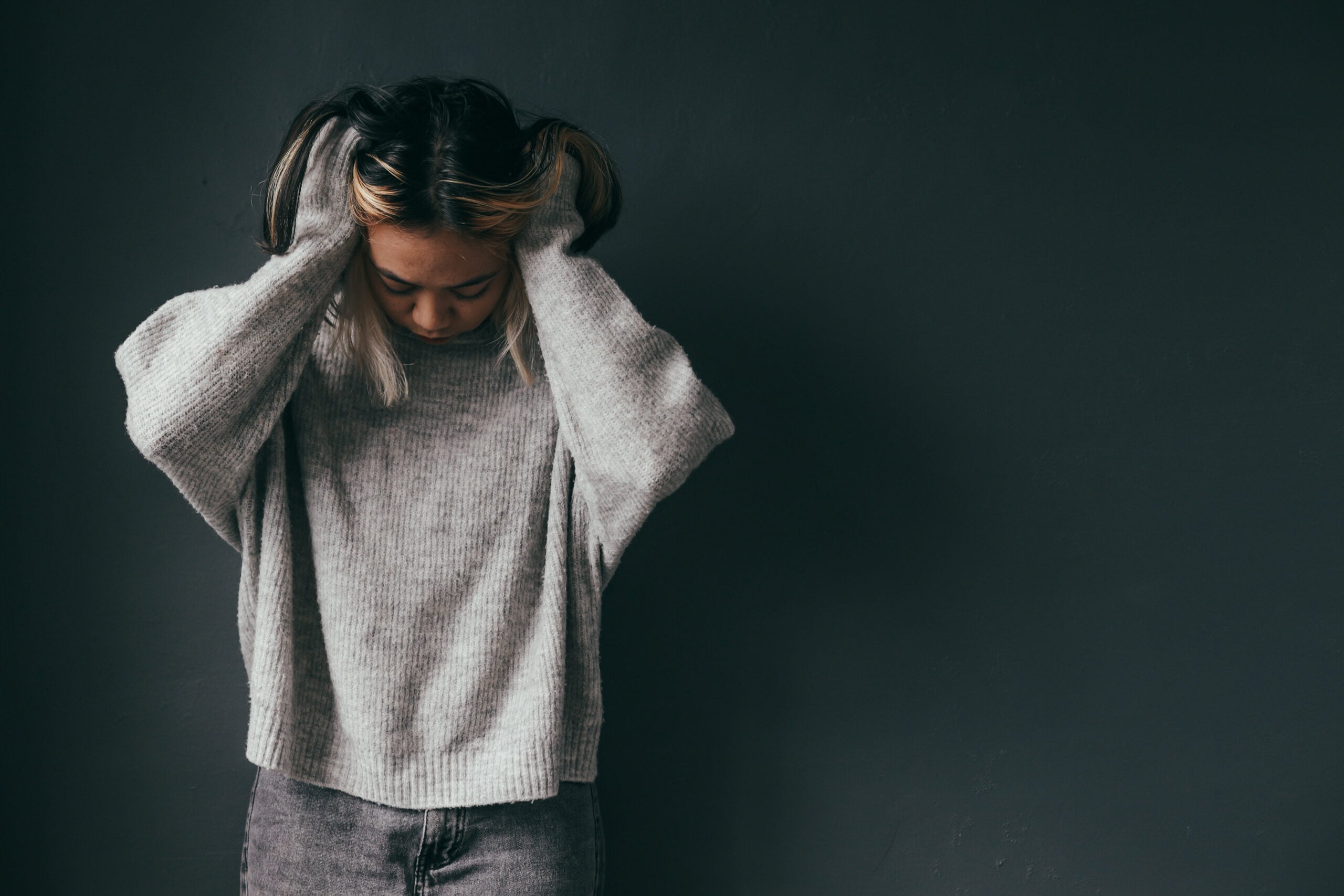 Young adult struggling with anxious thoughts and beginning therapy for anxiety