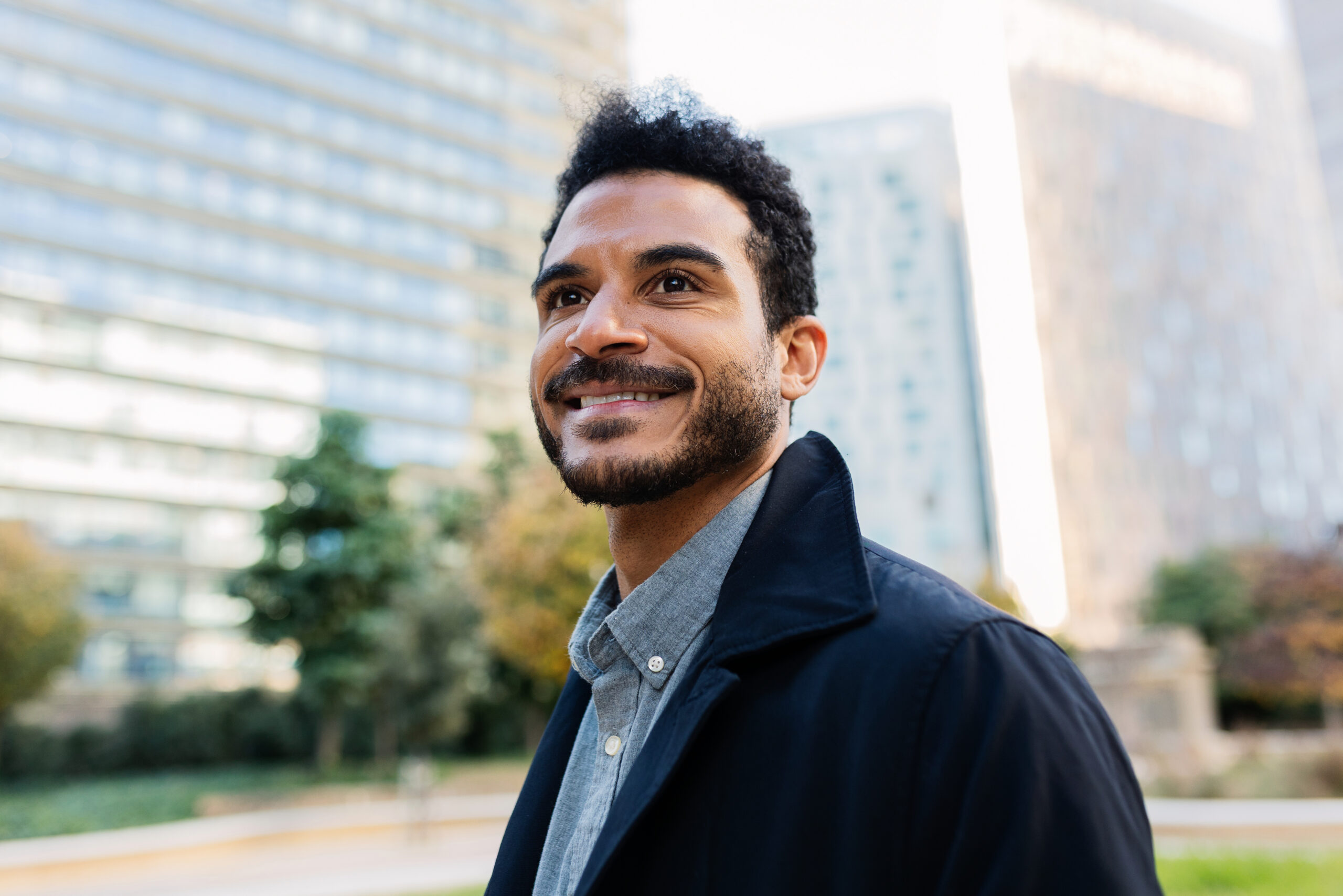 A professional in The Woodlands standing outdoors with a calm settled expression after beginning harm OCD treatment at Acceptance Path Counseling