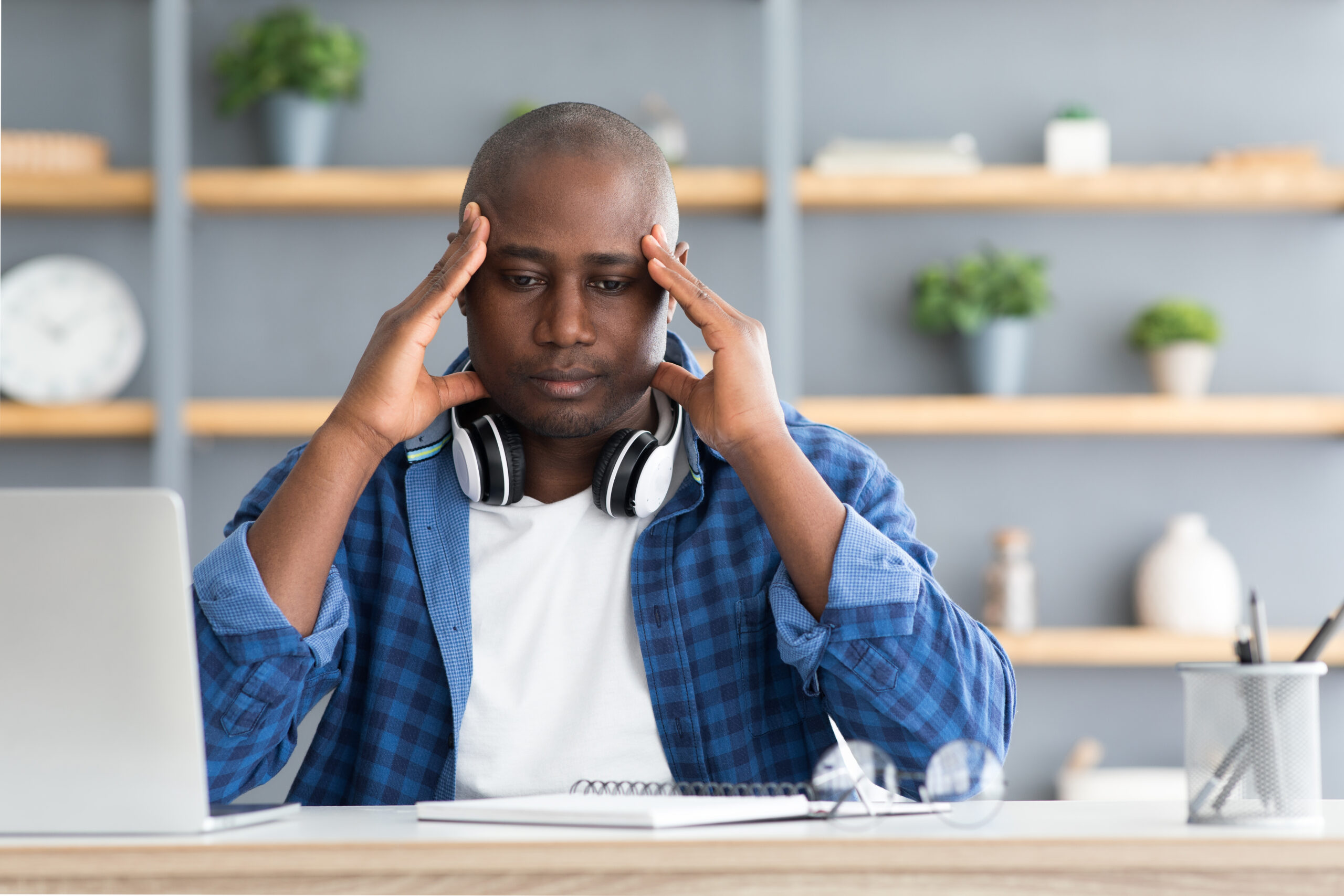 Migraine attack African american man suffering from headache at workplace while working on laptop Acceptance Path Counseling A visual desk timer ticking down next to a laptop in The Woodlands Emphasizes time blocking and behavioral adhd strategies for adults dealing with procrastination