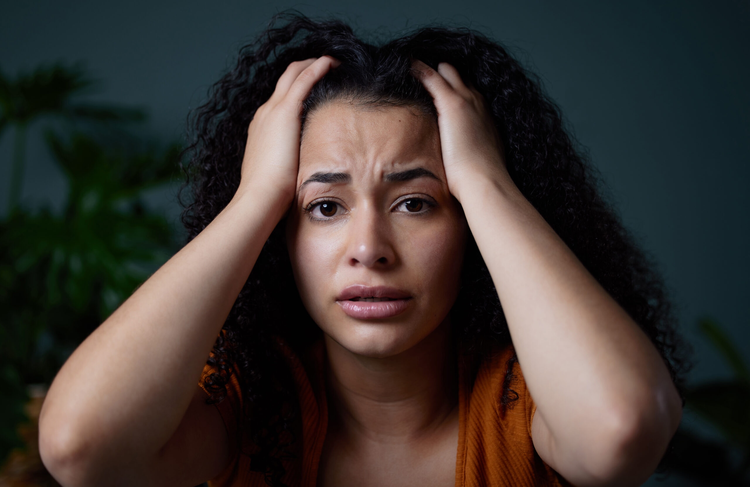 Woman experiencing emotional overwhelm while seeking therapy for anxiety support
