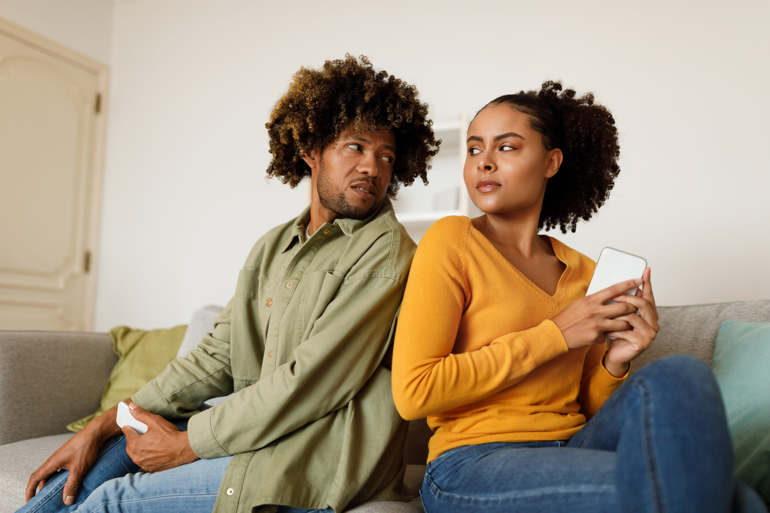 Acceptance Path Counseling A couple in Cypress sitting together but emotionally disconnected one partner caught in the reassurance loop of OCD relationship symptoms while the other watches in confusion a pattern addressed at Acceptance Path Counseling