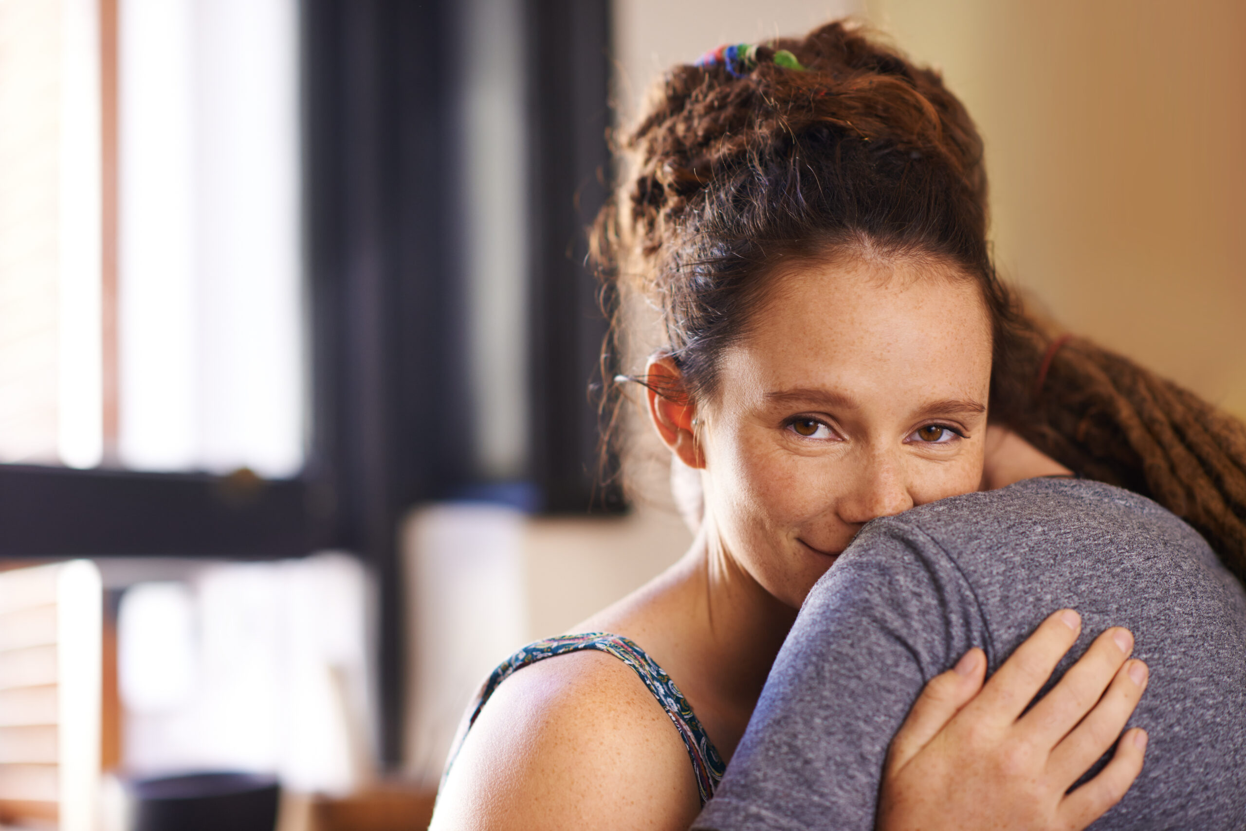 A woman offering a warm supportive embrace to a friend showing the power of meaningful human connection in overcoming depression