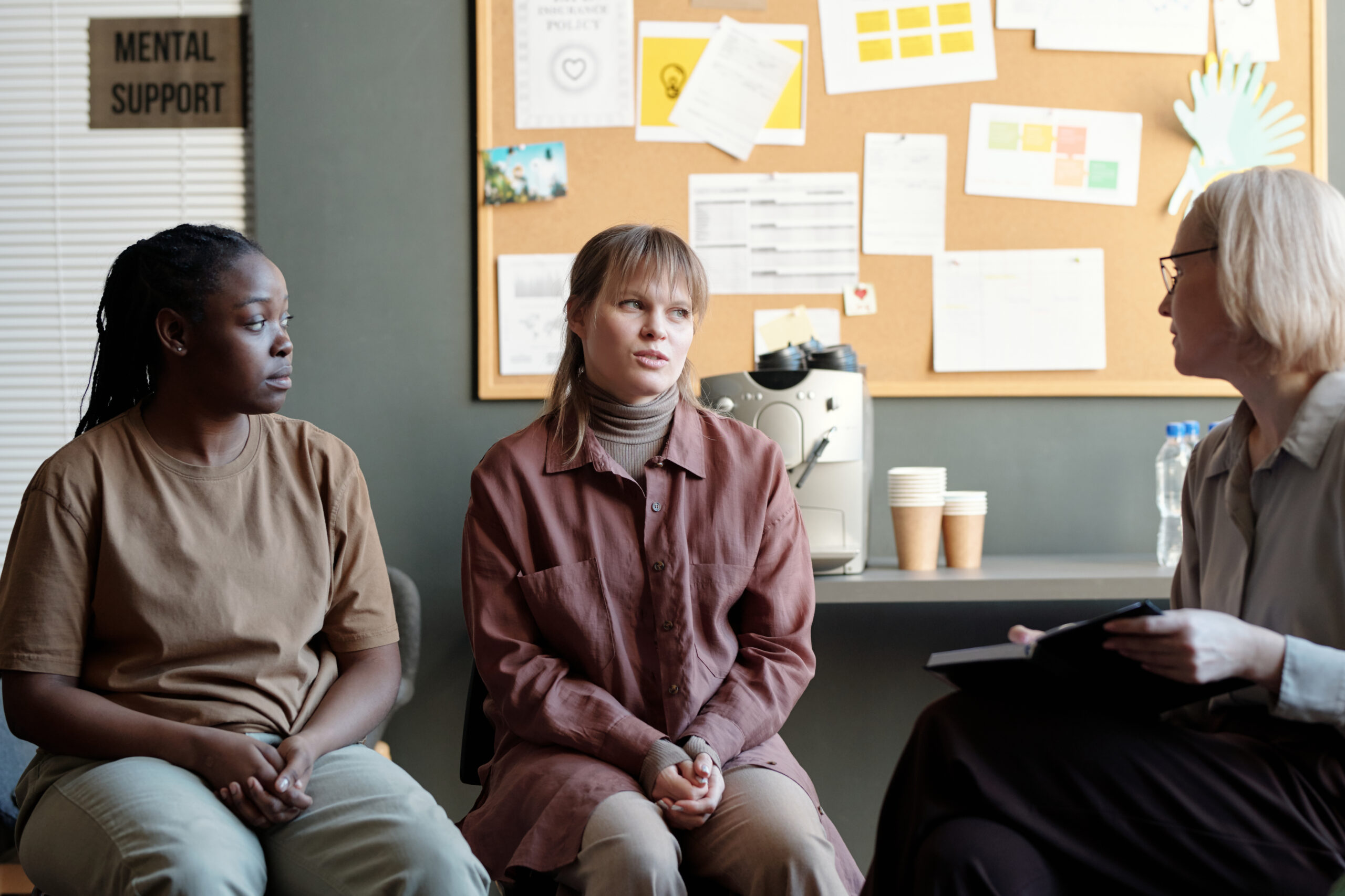 Mental health professional explaining anxiety treatment options to a client in therapy