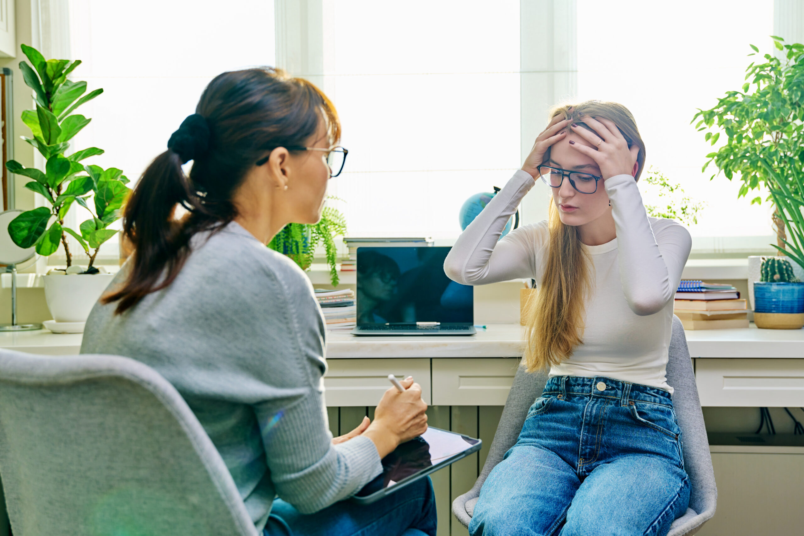 Therapists for anxiety disorders helping a client manage overwhelming thoughts during a therapy session