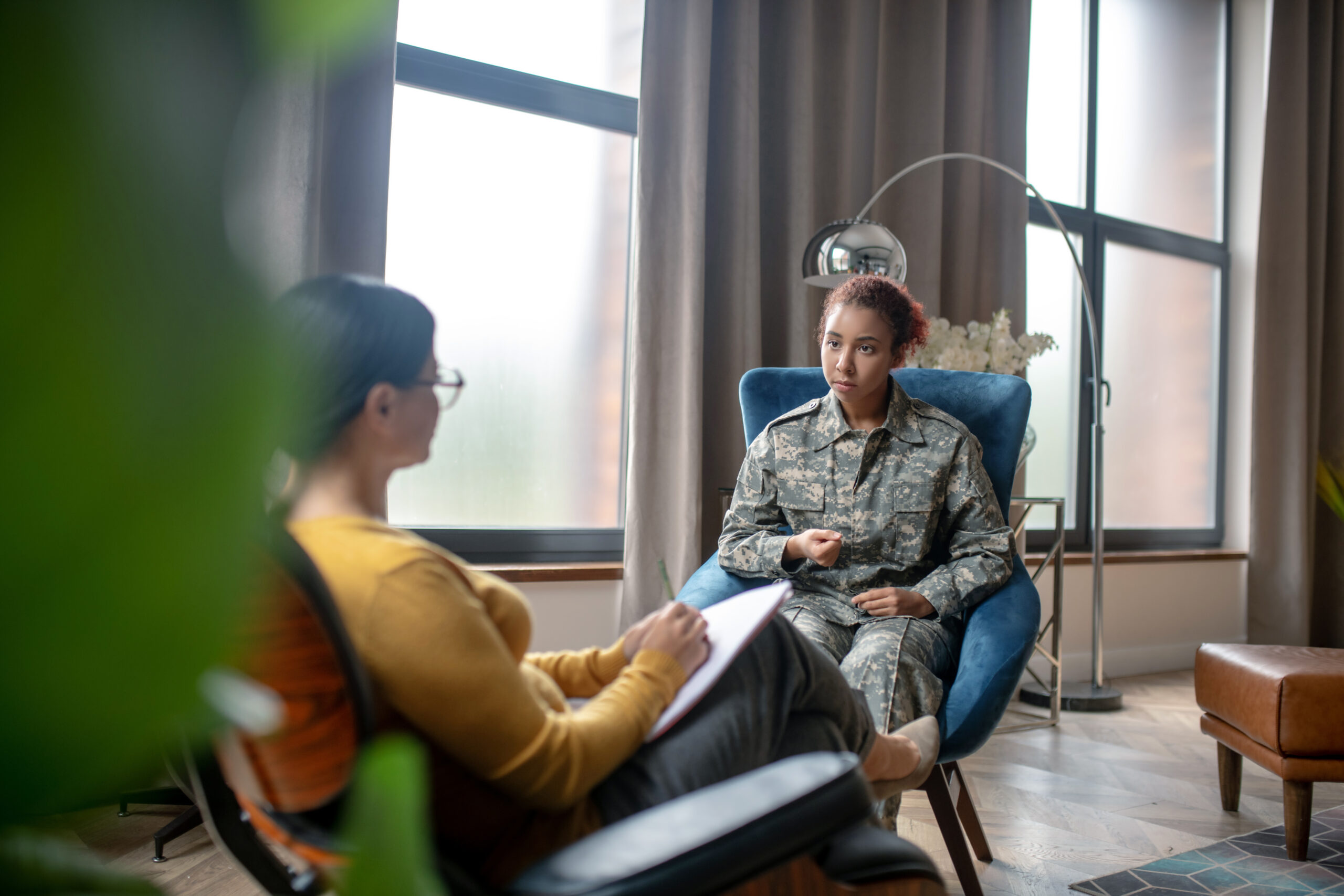 Woman having military rehabilitation speaking with psychoanalyst Acceptance Path Counseling Adult discussing personal challenges during a trauma focused therapy appointment