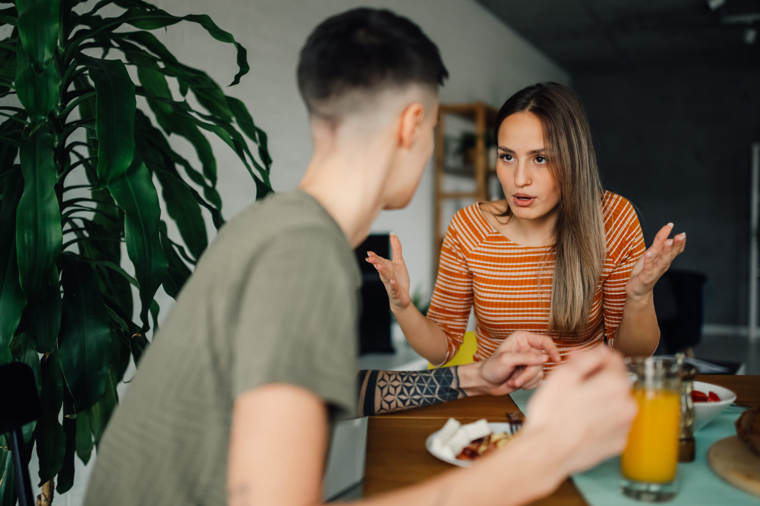 Lesbian couple having breakfast and discussing problems at home Acceptance Path Counseling Compassionate communication when talking to someone about eating disorder concerns