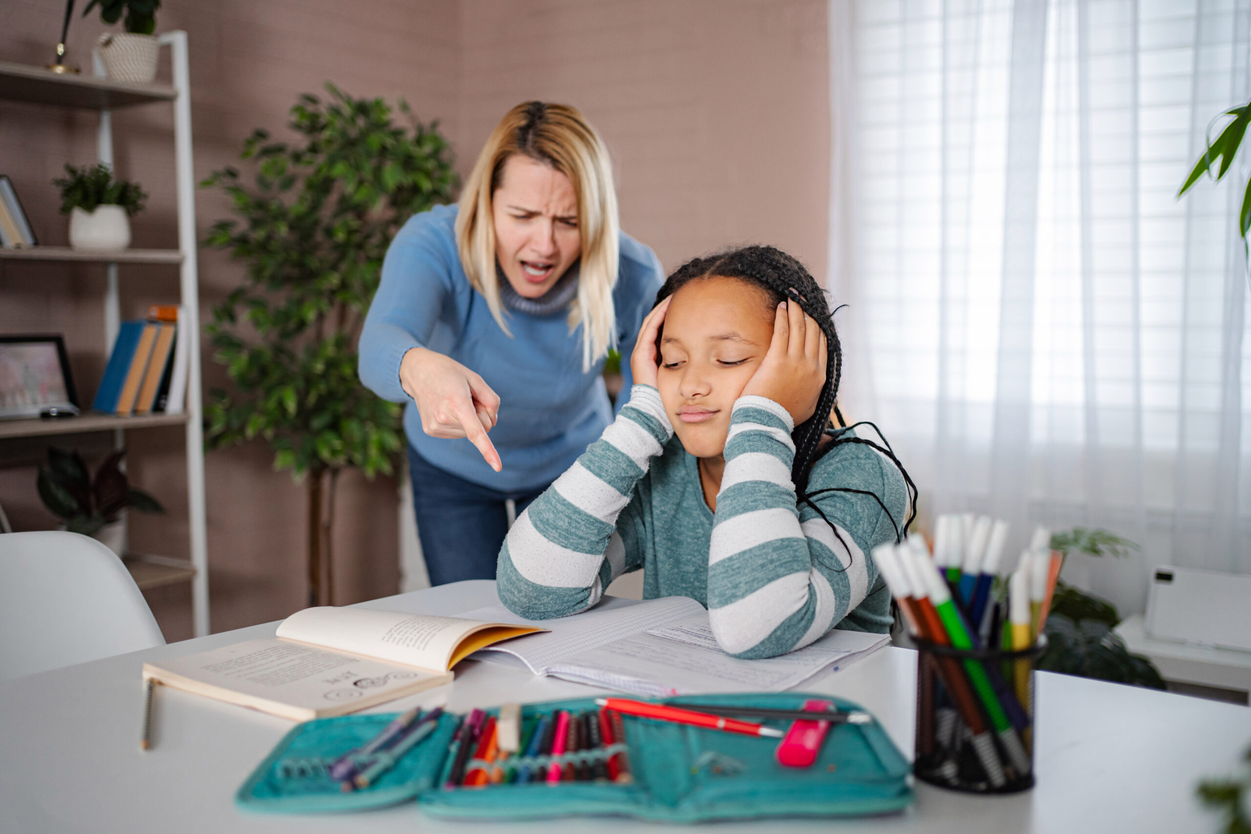 Adult covering their ears while experiencing ADHD overstimulation in a busy environment