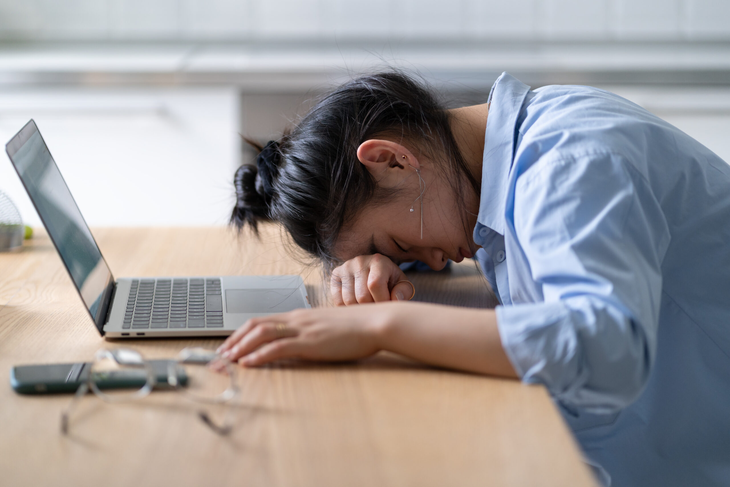 Work burnout Tired asian woman putting head down on table suffering from chronic job stress Acceptance Path Counseling Illustration of depression and fatigue affecting emotional well being and daily life