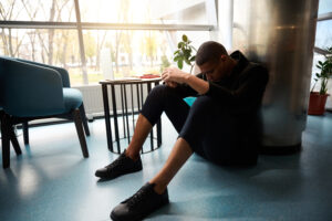 Acceptance Path Counseling Person experiencing depression and fatigue while sitting with low energy at home