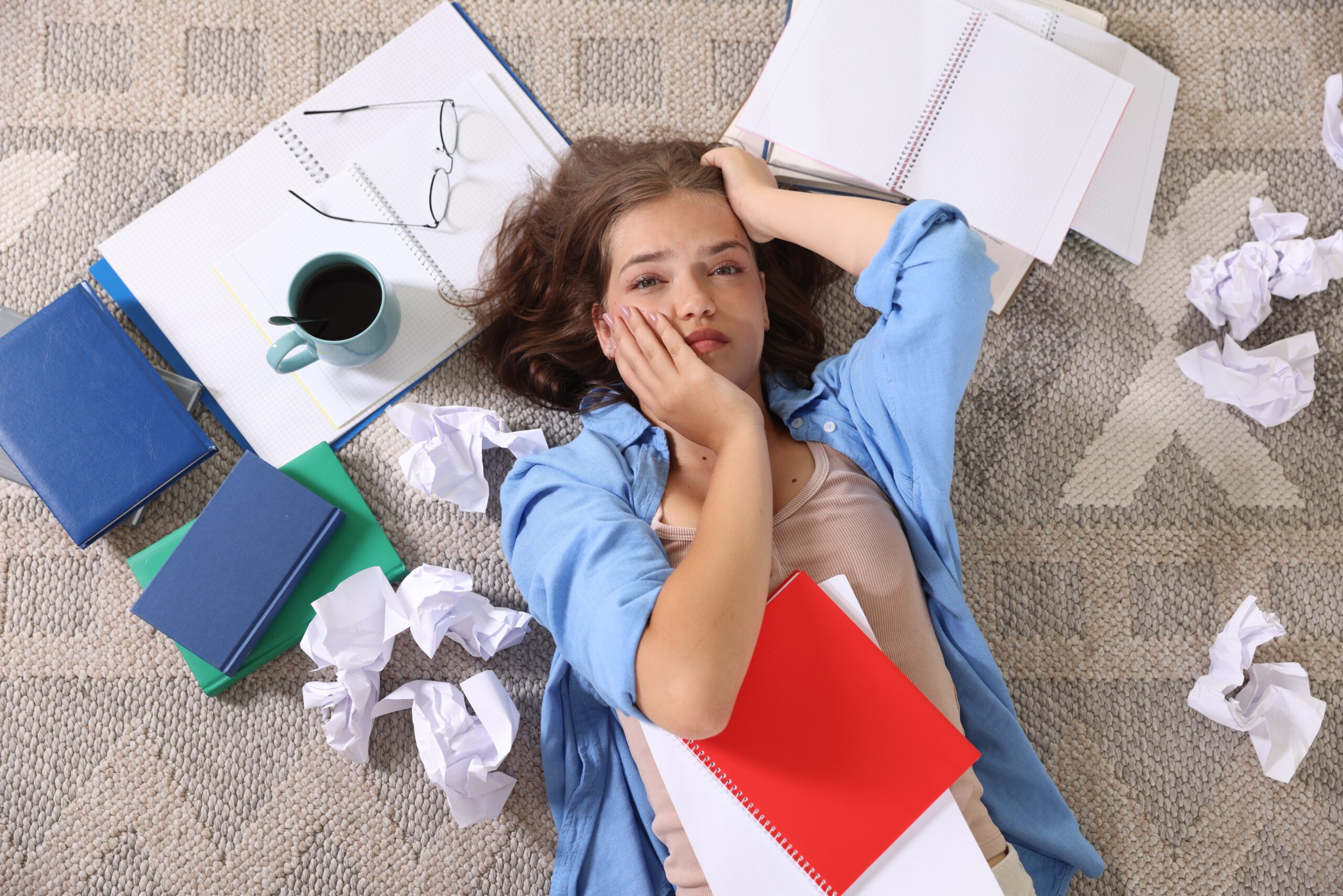 tiredstudentamongnotebookscrumpledpaperand20260507200326utc Acceptance Path Counseling Person overwhelmed by ADHD burnout while trying to manage daily responsibilities