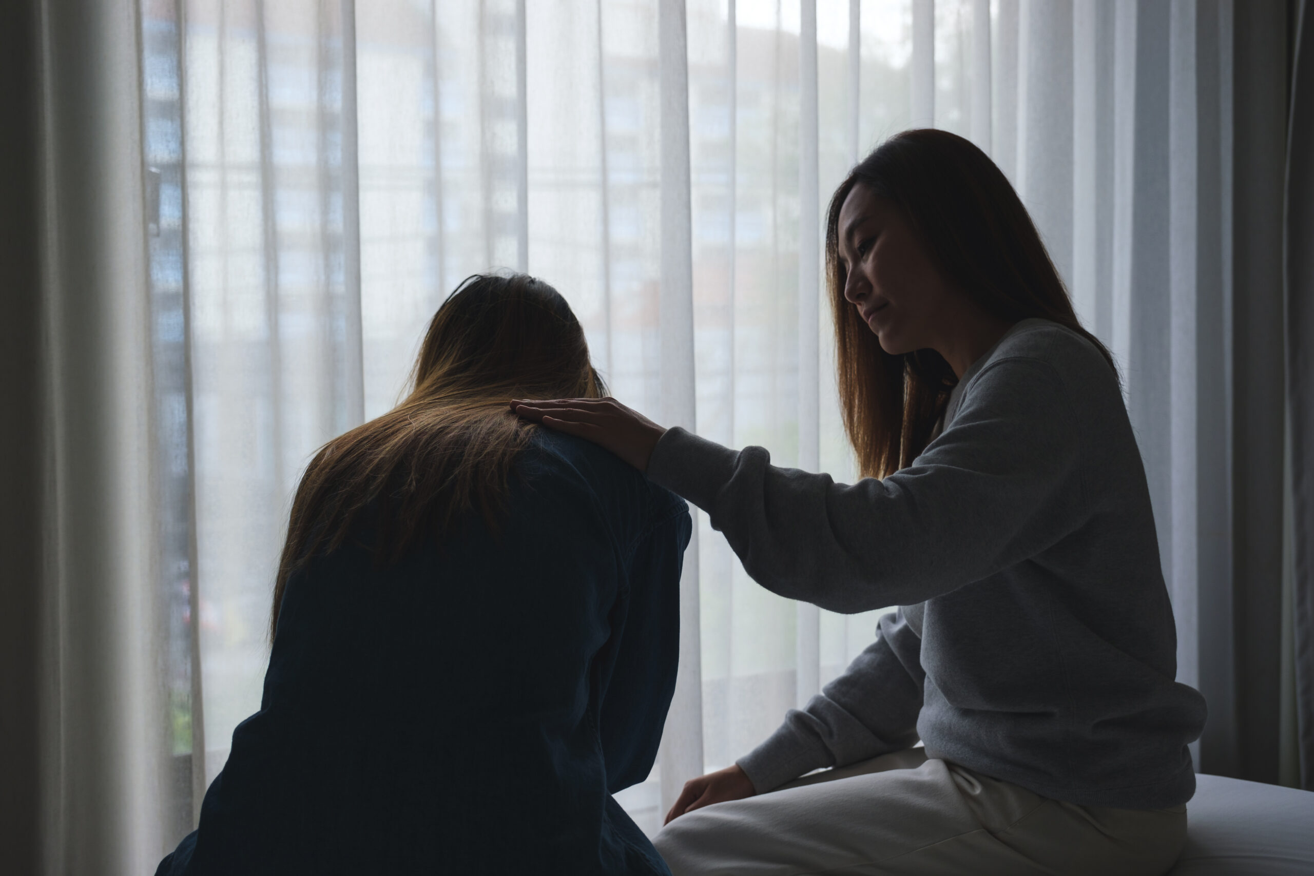 A woman touching her friend shoulder to comforting and giving en Acceptance Path Counseling Counseling session focused on understanding BPD triggers and developing healthier responses