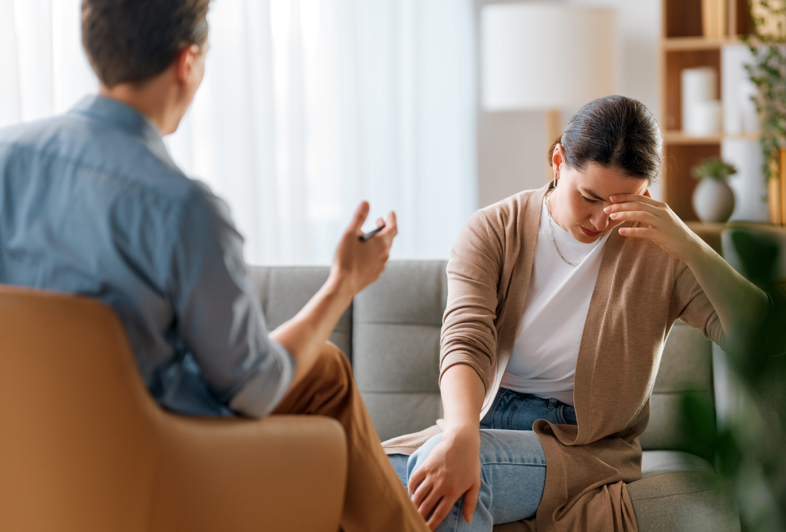 Therapist supporting a client who feels pressured to hide smiling depression behind productivity