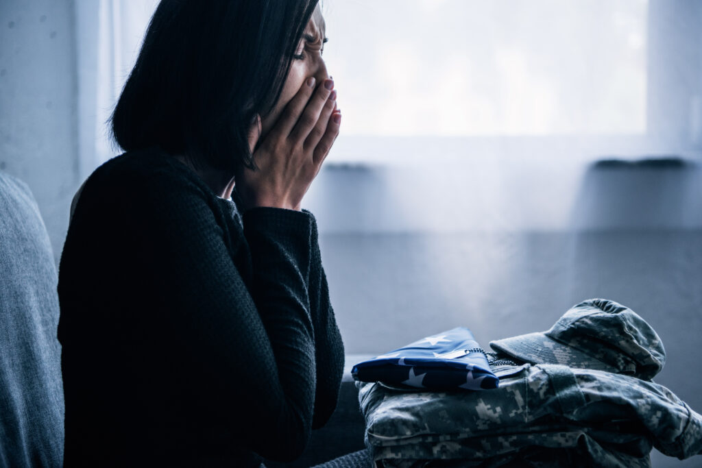 Person experiencing PTSD triggers after hearing a sudden loud noise