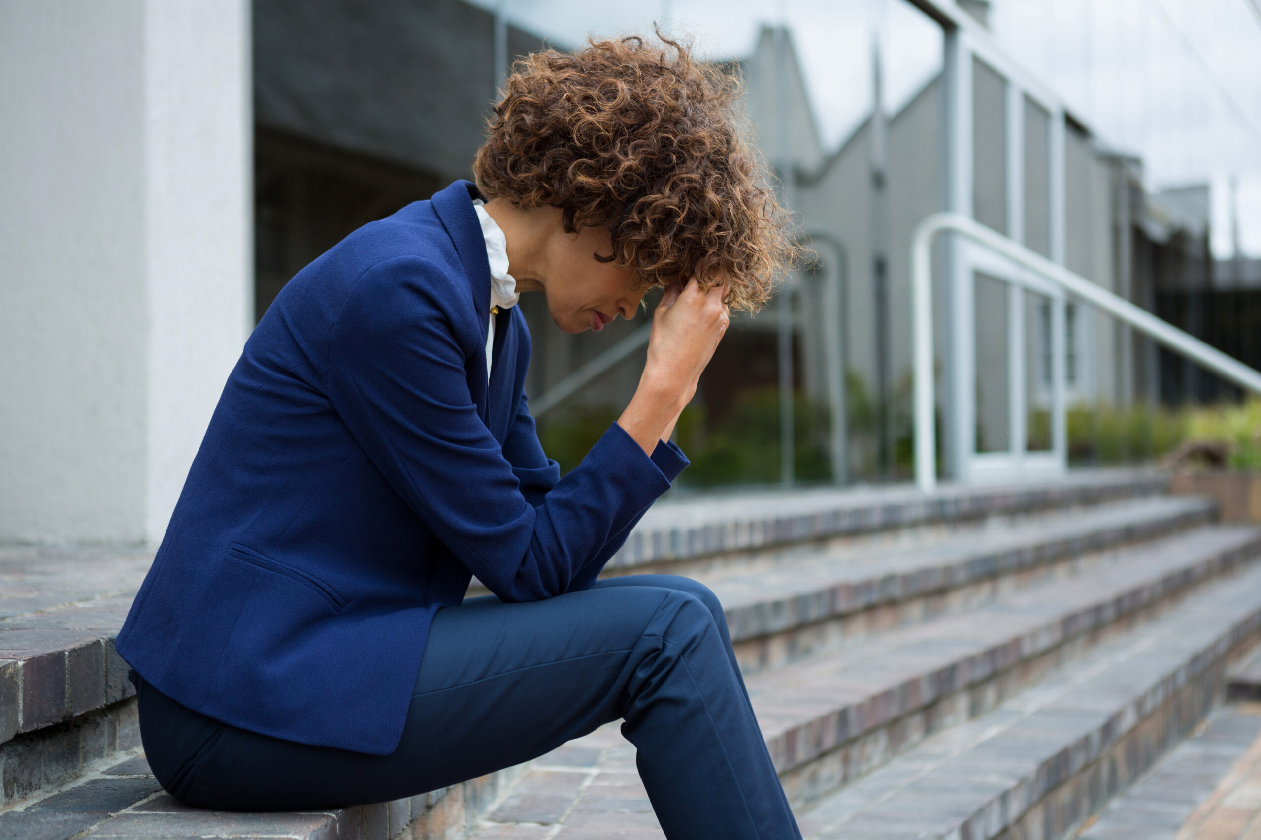 Person feeling emotionally drained while balancing work demands and symptoms of depression