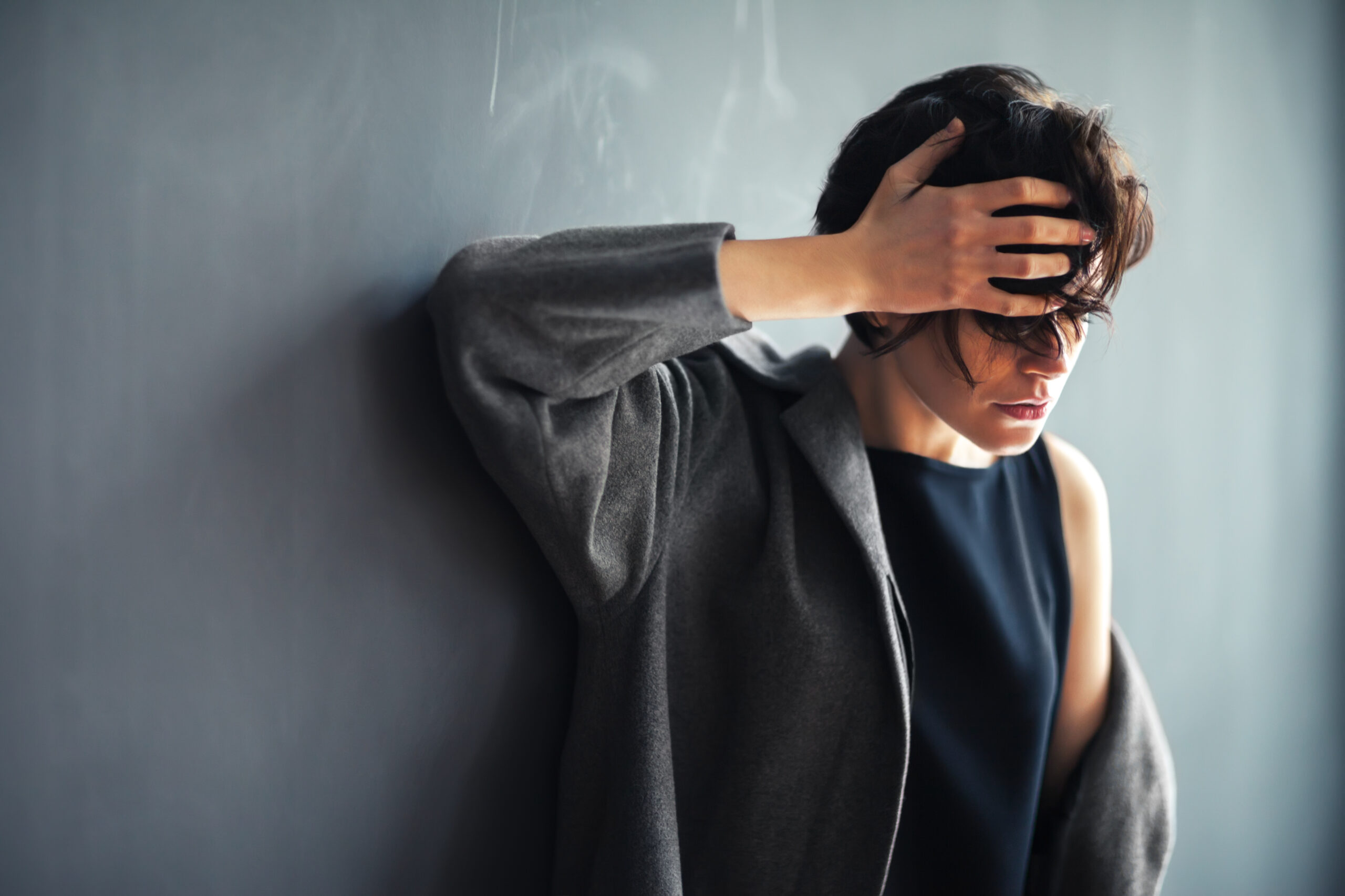 Portrait of tired beautiful woman on dark background Acceptance Path Counseling Person learning how BPD may influence abandonment fears impulses and emotional reactions