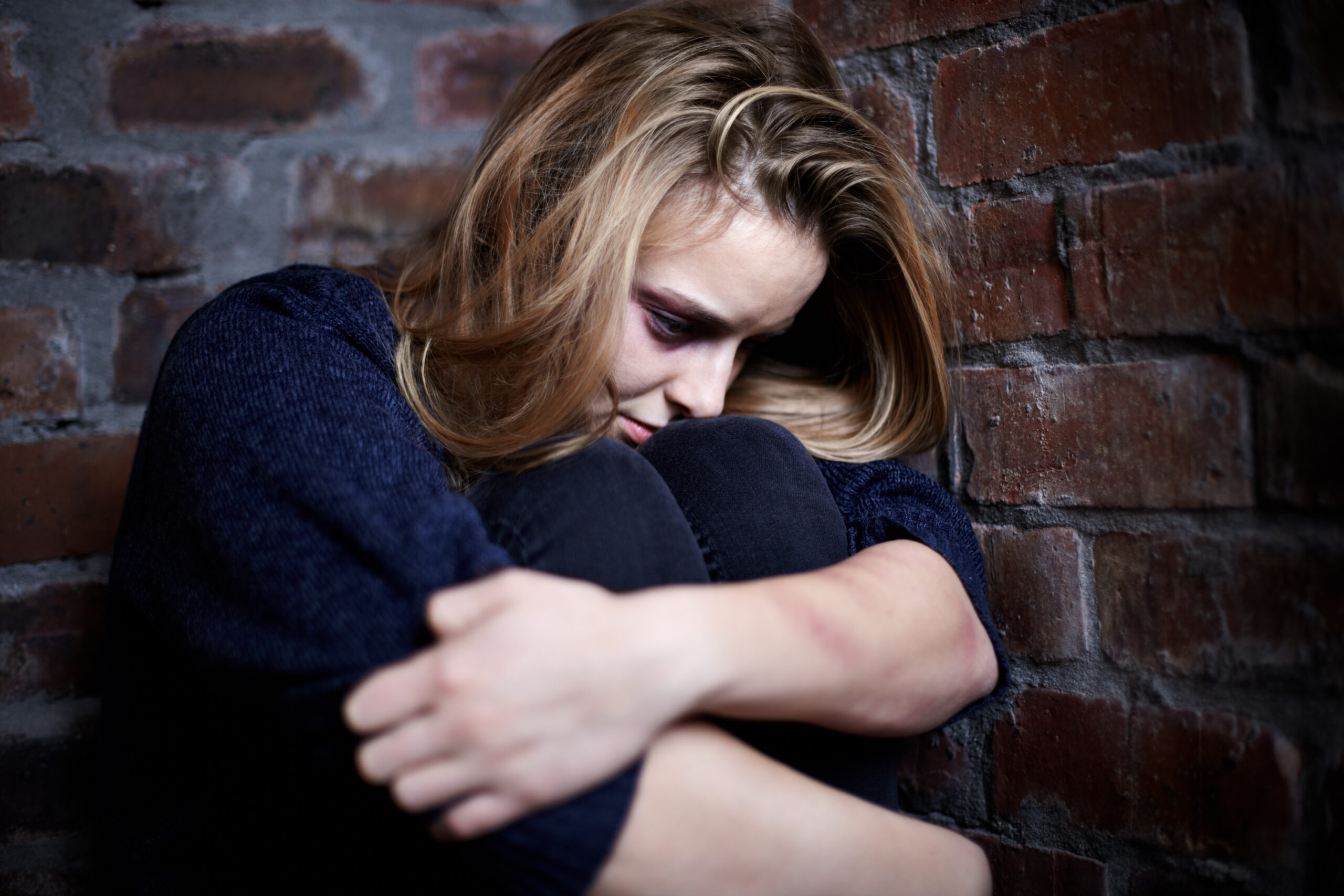 Person sitting alone after a social event and reflecting on smiling depression symptoms