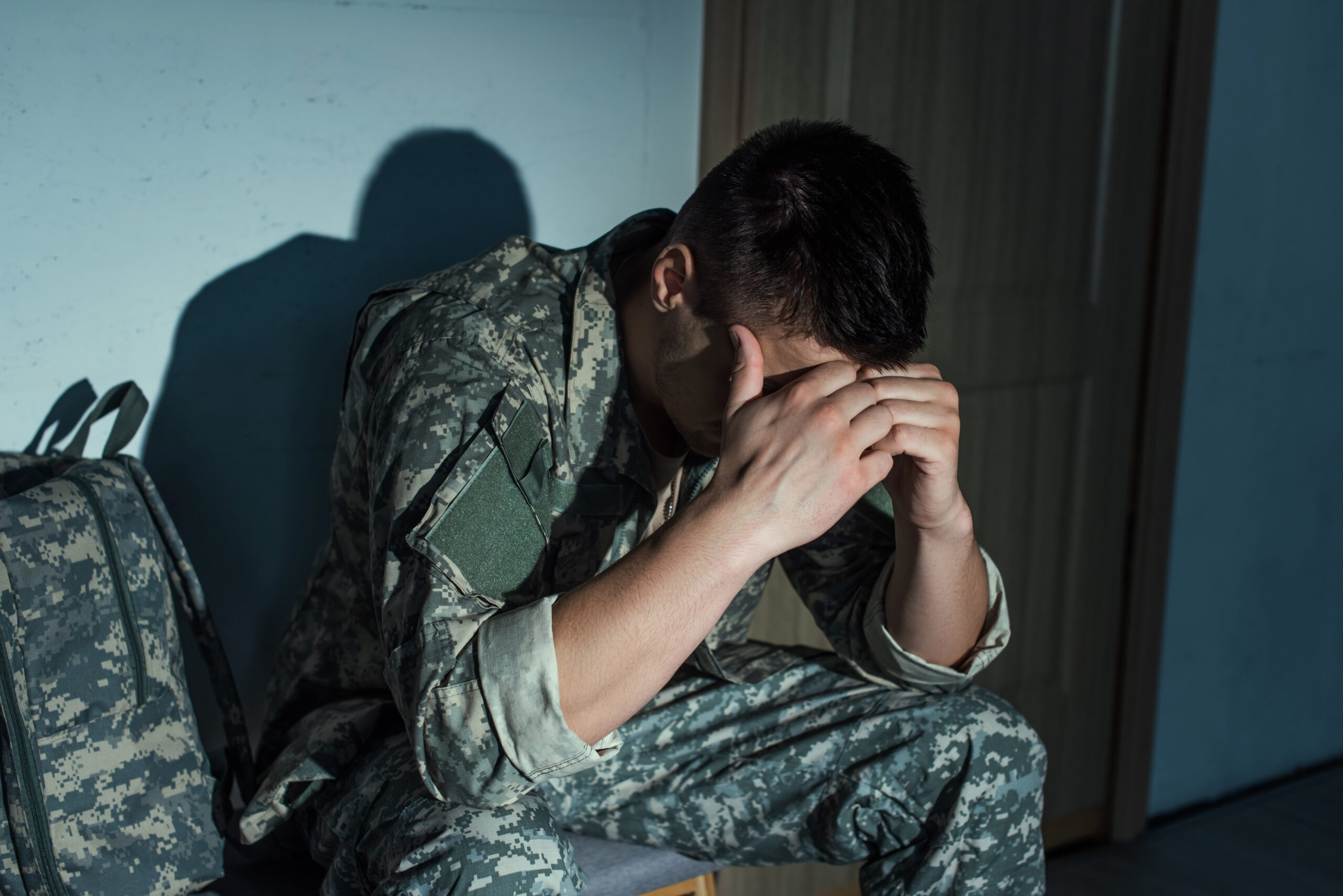 Individual lying awake because fear of PTSD nightmares makes returning to sleep difficult