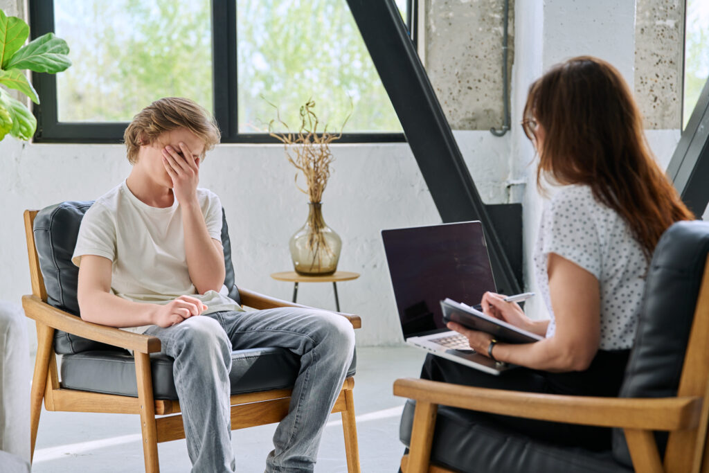 Adult experiencing ADHD task paralysis while trying to begin work at a desk.