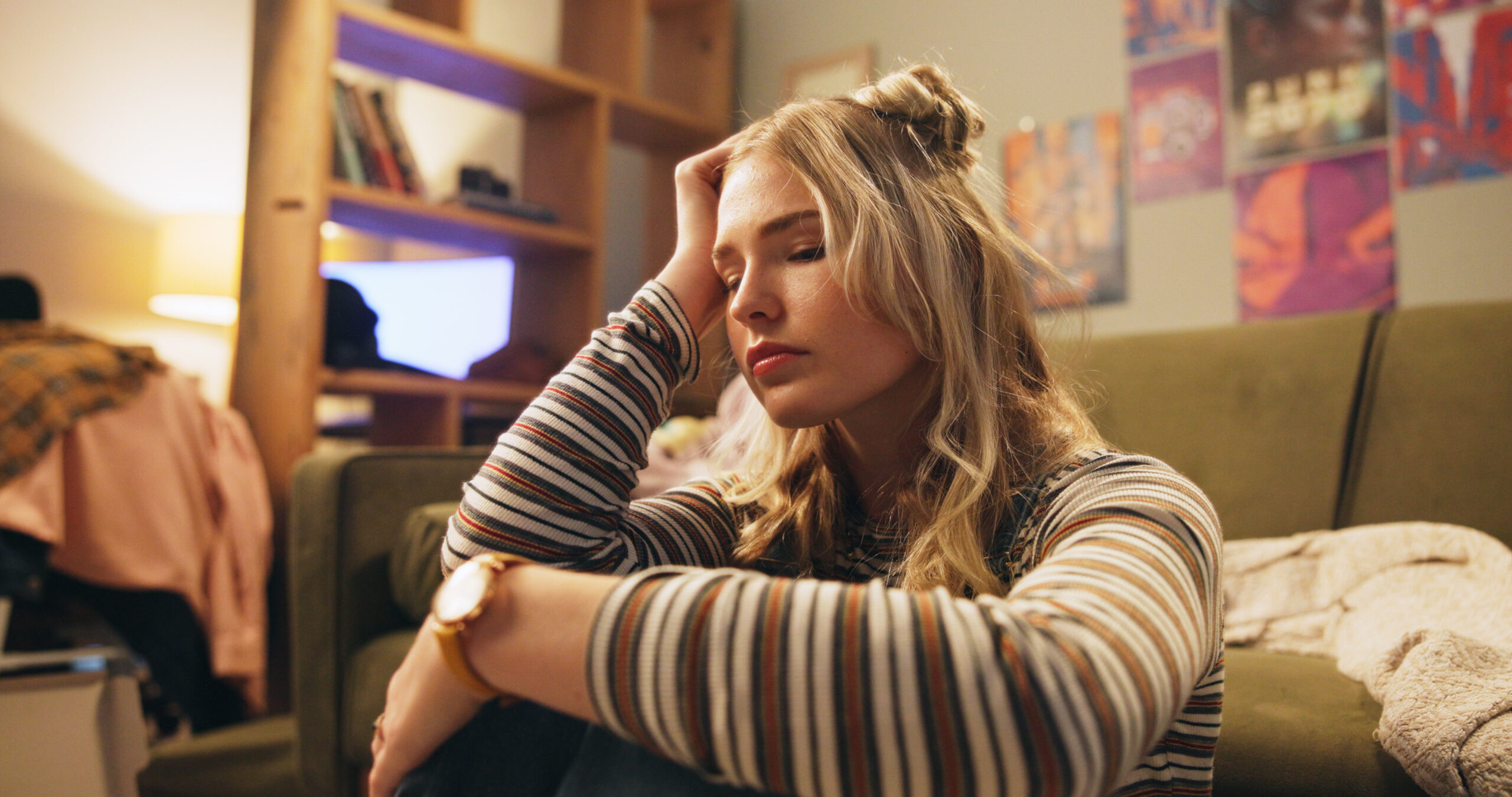 Individual sitting upright at night and using slow breathing during a nocturnal panic attack