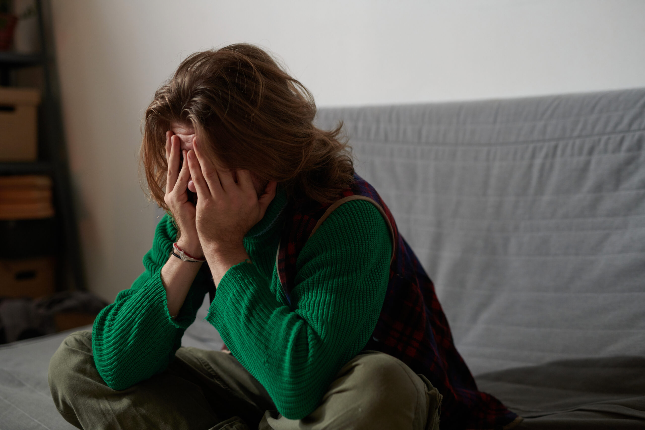 Person resting in a dark bedroom after the intensity of a nocturnal panic attack subsides