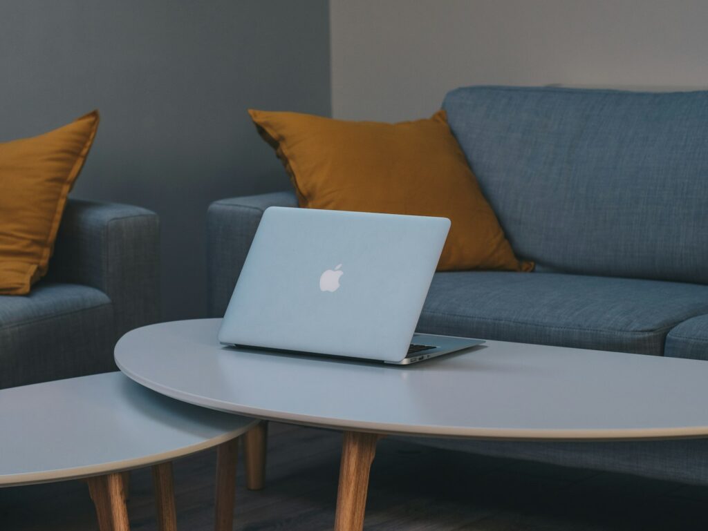 Laptop open on a coffee table ready for an online counseling session at home