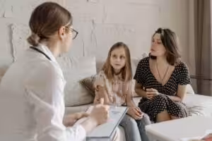 pexelspaveldanilyuk7653094 Acceptance Path Counseling Adult speaking with a counselor in a private therapy room